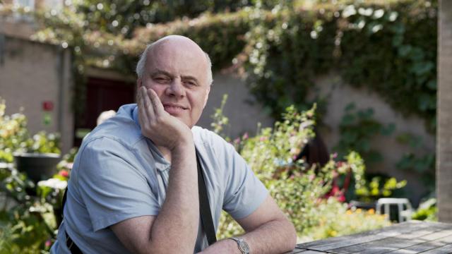 Wayne Chapman sitting outdoors smiling