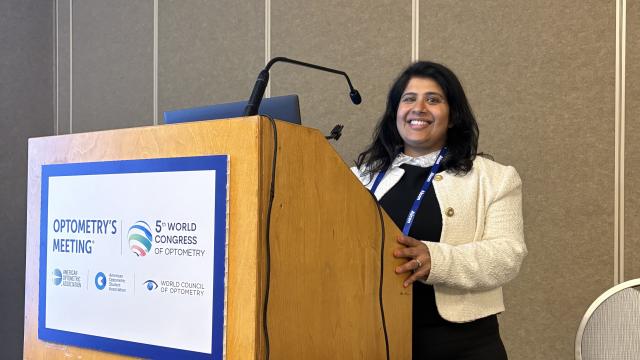 Sonal standing behind a lecturn