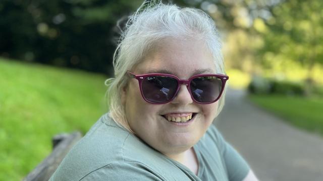 Lucy smiling in a park