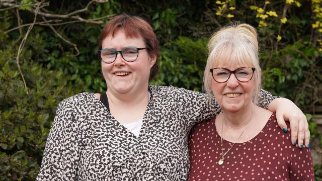 Grace and her support worker smiling