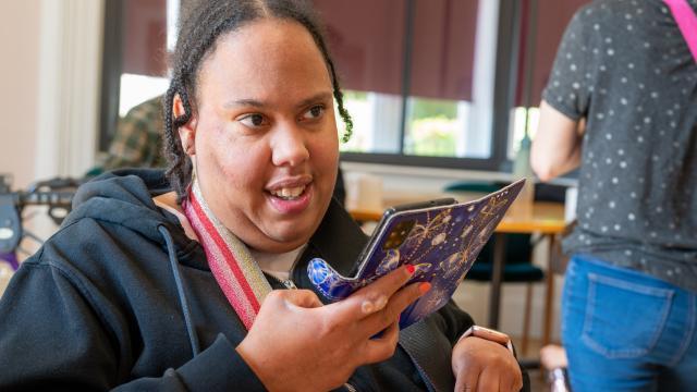 Tamika using her phone to make an important phone call