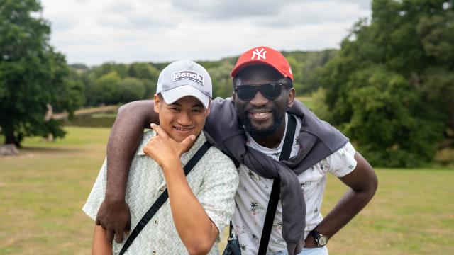Giban and his support worker smiling in a field
