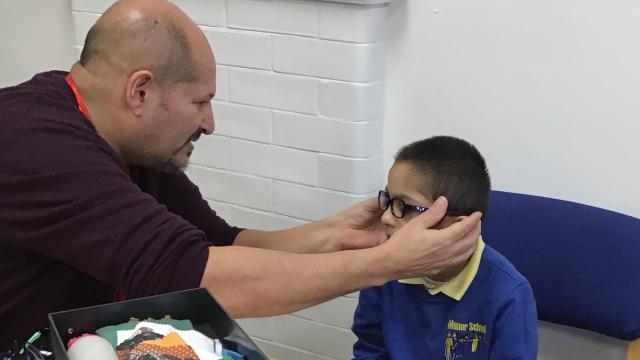 Mitch fits glasses on Zian