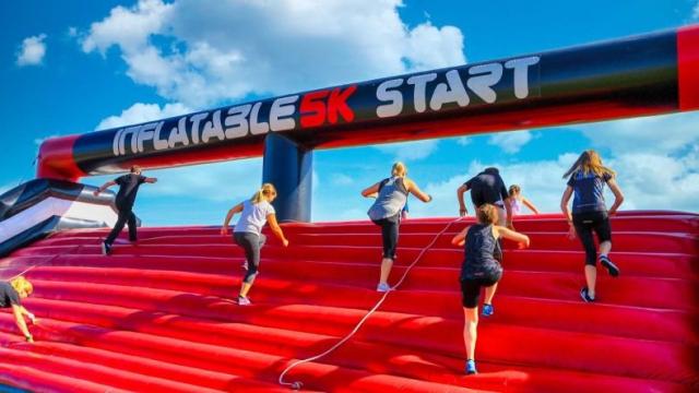 People running over an inflatable obstacle course