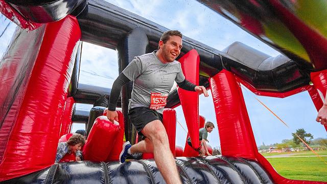 People running over an inflatable obstacle course