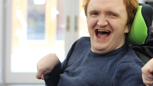 James smiling in his room