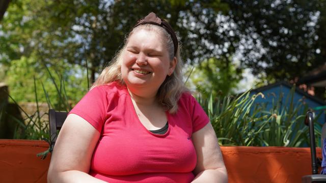 Joanne smiling in her garden