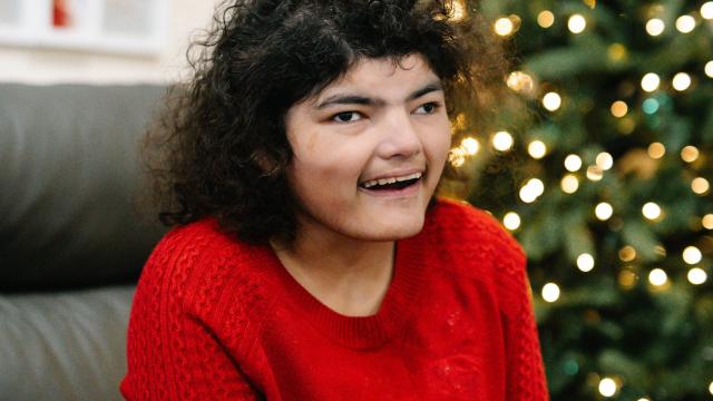 Nadia smiling in her home