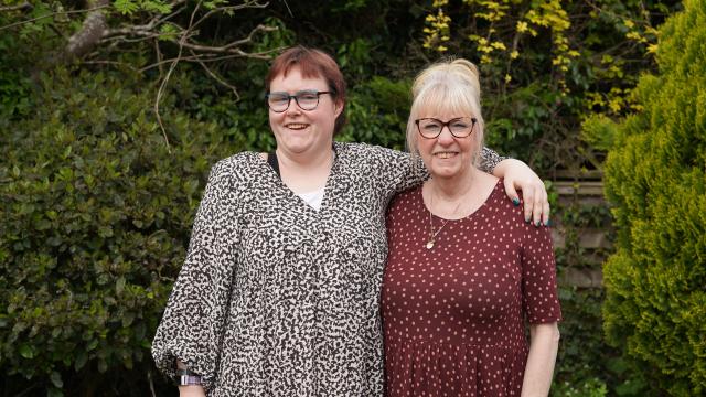 Grace and a support worker in the garden