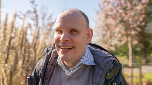Jan smiling in a garden