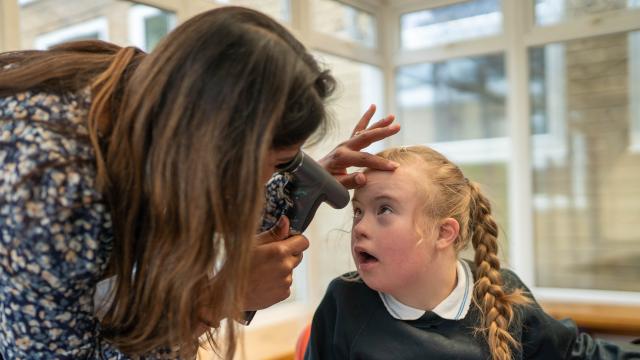 Malvi providing an eye check in a special school