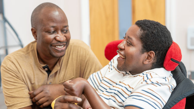 Sadick smiling with his support worker