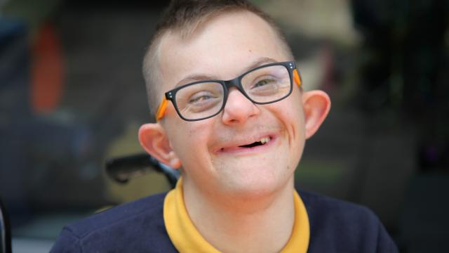 A photo of Alexandru smiling with his new glasses