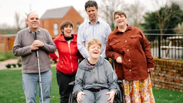 Our listen up team smiling together outside 